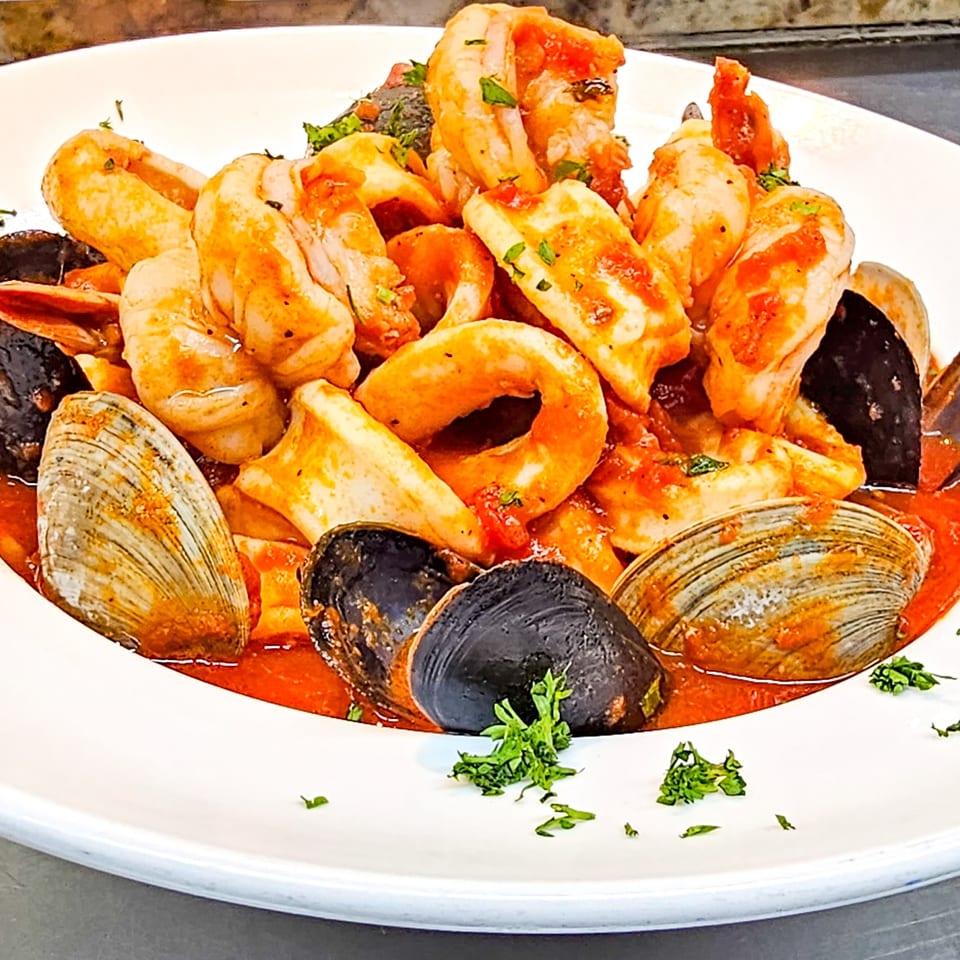Seafood medley of shrimp, mussels, clams, and calamari served in tomato sauce with fresh parsley.